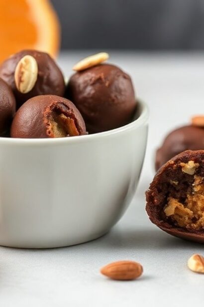 Healthy Orange Bites coated in dark chocolate, sprinkled with fresh orange zest.