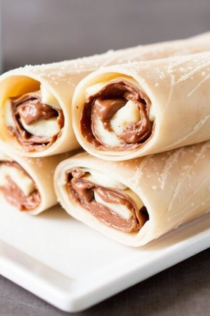 Crispy Nutella banana spring rolls with golden wrappers and sliced bananas, ready to serve.