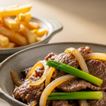 Delicious Classic Beef & Onion Stir-Fry Paired with Crispy Fries
