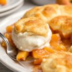 Irresistible Southern peach cobbler with fluffy biscuit topping.