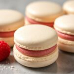 Perfectly light almond meringue macarons with raspberry bliss filling.