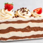 Classic Neapolitan ice cream scoops: chocolate, vanilla, strawberry swirl.
