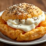 Fluffy fried dough with prosciutto and stracchino cheese delight.