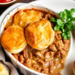 Hearty John Wayne casserole with golden biscuit topping.