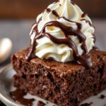 Decadent brownie sundae with hot fudge and whipped cream bliss.
